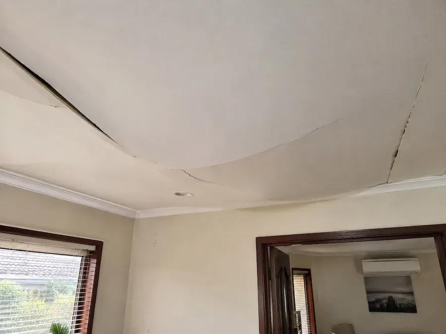 Ceiling sheet that has dropped from the joists and is hanging into a living room
