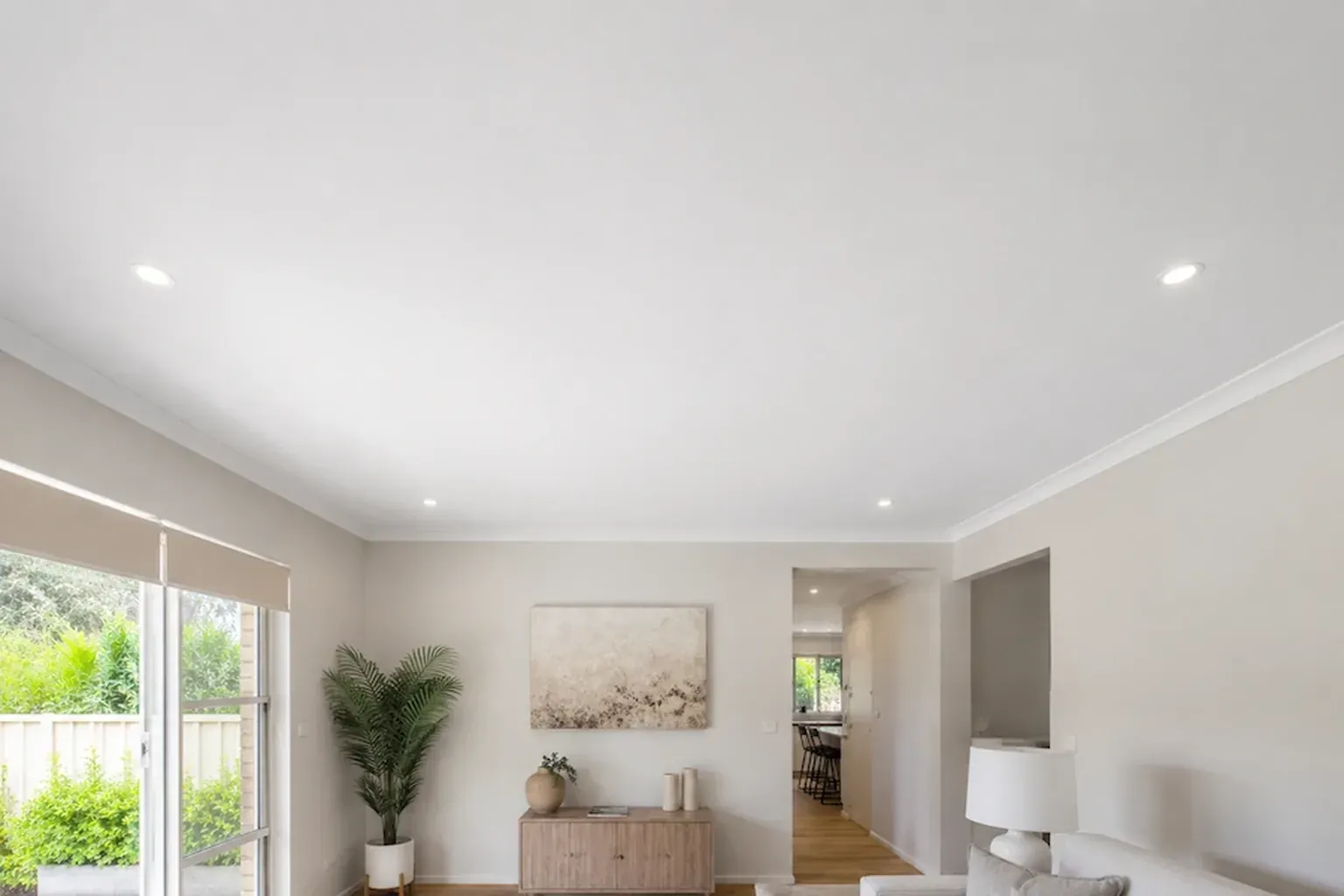 Living room with a newly finished ceiling and downlights, furniture back in place