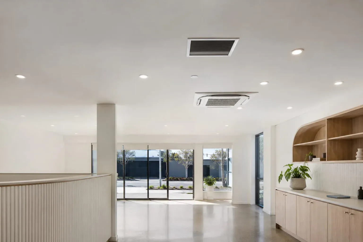 Finished plasterboard ceiling with a cassette air-conditioner and downlights in a commercial fit-out